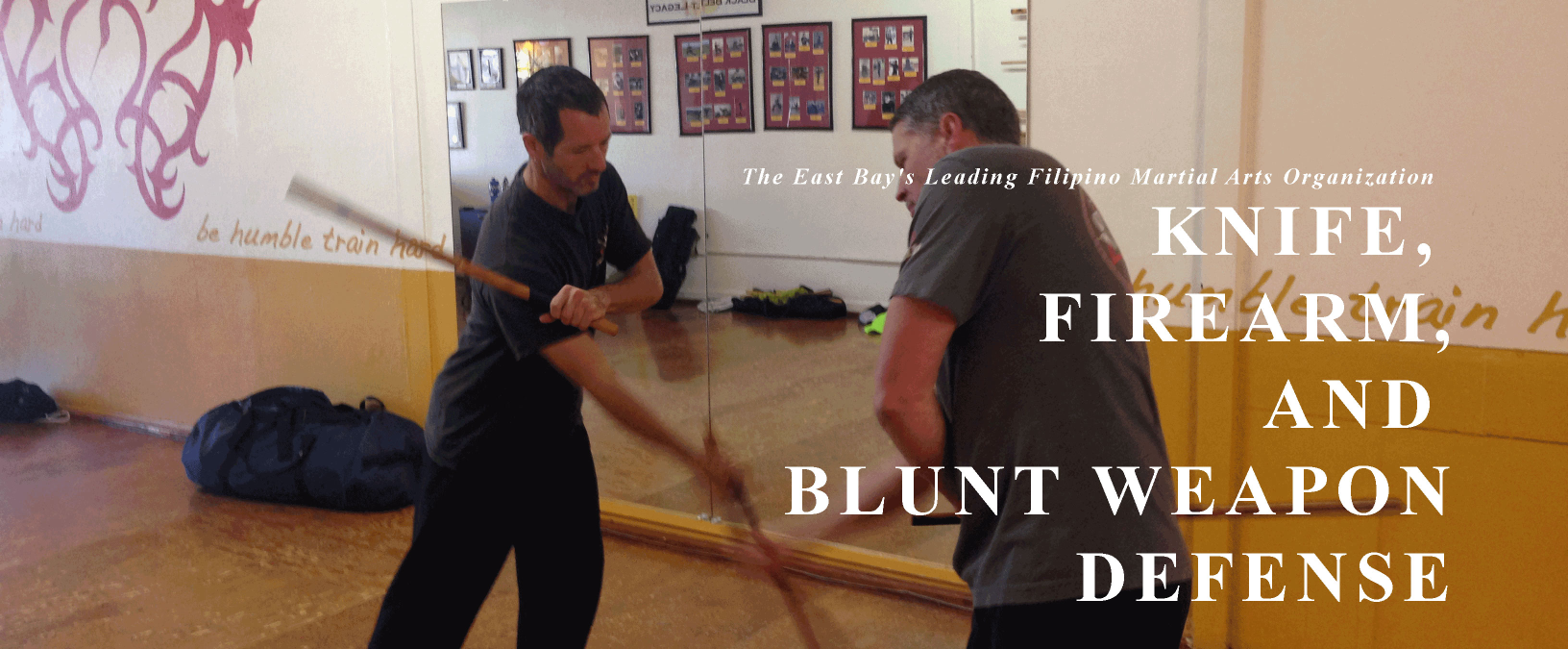 two students doing stickfighting, text label: Knife, Firearm and Blunt Weapons Defense