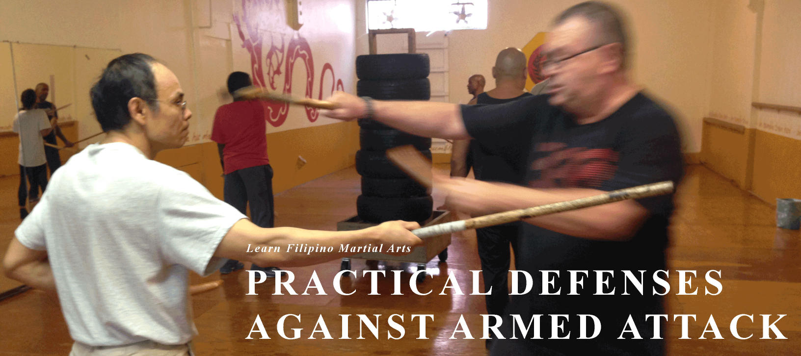 two students doing stickfighting, text label: Stick and Knife Practical Applications