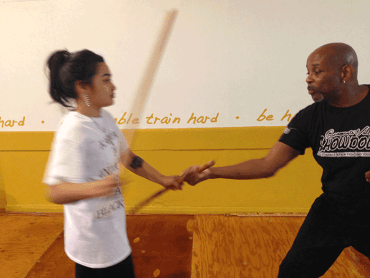 Instructor and Student practicing stickfighting